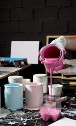 high-angle-artist-pouring-pink-paint-from-can high-angle-artist-pouring-pink-paint-from-can