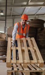 man-working-with-heavy-wooden-materials