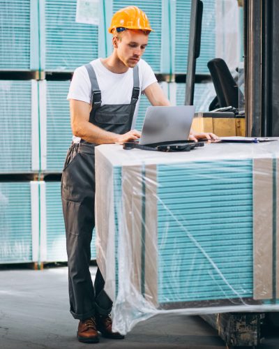 Young man working at a warehouse with boxes Import and export trading